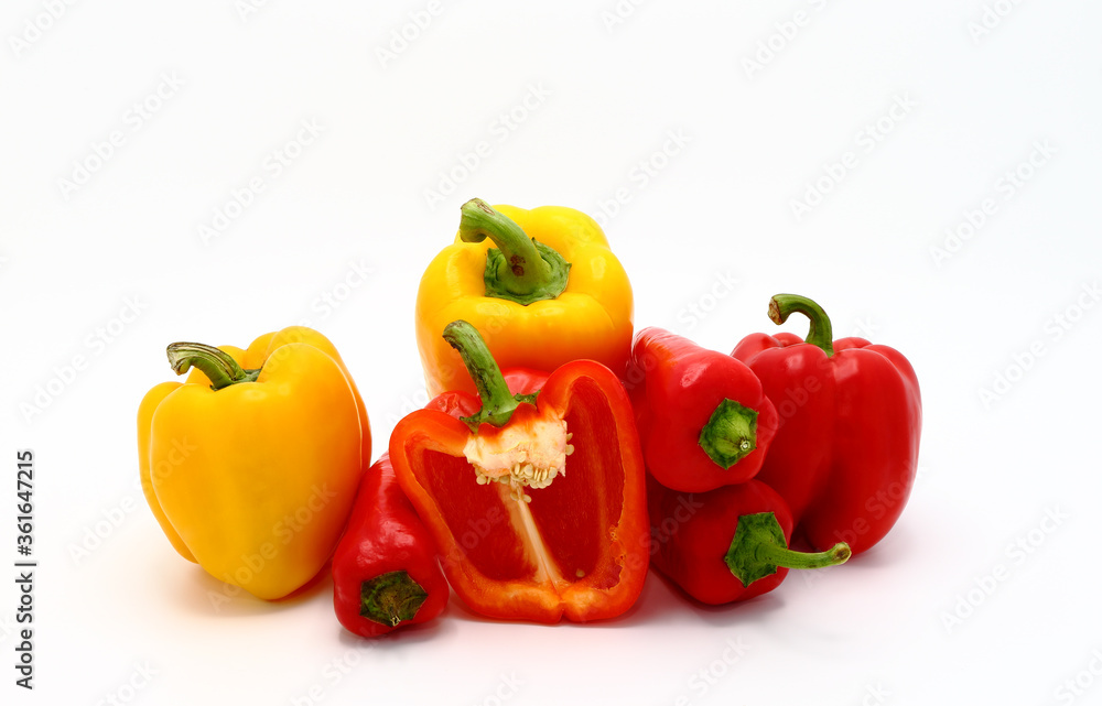 Composition of several sweet peppers and their halves of different colors on a light background. Natural product. Natural color. Close-up.