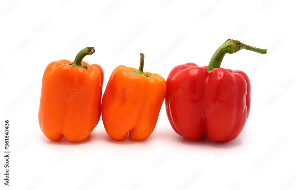 Two red and two orange ripe sweet peppers on a light background. Natural product. Natural color. Close-up. Two red and two orange ripe sweet peppers on a light background. Natural product. Natural color. Close-up.