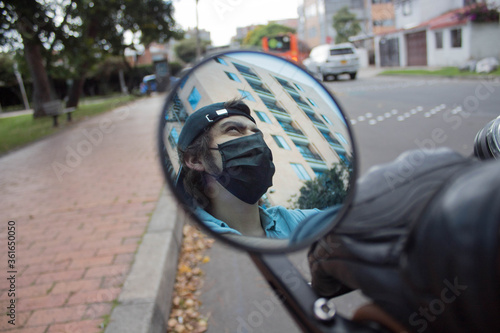 Rider with a mask on the reflection of a mirror