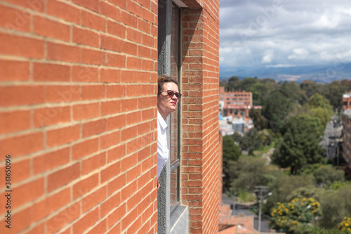 Woman looking at the horizon out of a window