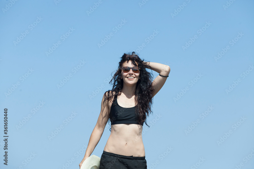 Wanderlust of a sporty and young woman The woman is on top of a mountain overlooking the peaks of the tramuntana in Majorca, The woman is wearing black trekking clothes, a hat and glasses. Summer Wanderlust of a sporty and young woman The woman is on top of a mountain overlooking the peaks of the tramuntana in Majorca, The woman is wearing black trekking clothes, a hat and glasses. Summer