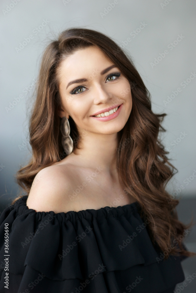 Young beautiful pretty woman with perfect skin and long curly hair with perfect friendly white smile looking at you Young beautiful pretty woman with perfect skin and long curly hair with perfect friendly white smile looking at you