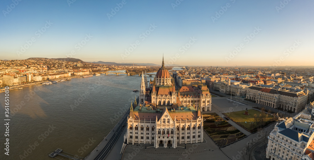 Panoramic aerial drone shot of south side facade of Hungarian Parliament during Budapest sunrise