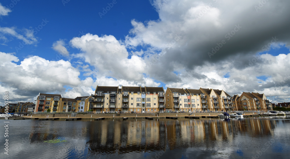 Marina Apartment blocks with big bright cloudy sky and reflections