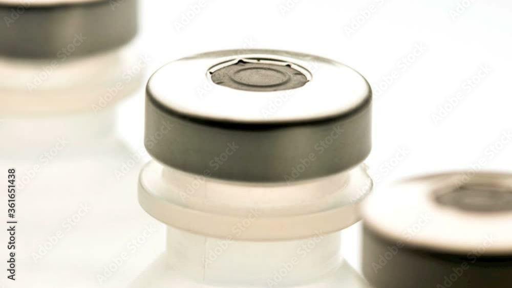 Row of medical vials containing saline solution Row of medical vials containing saline solution