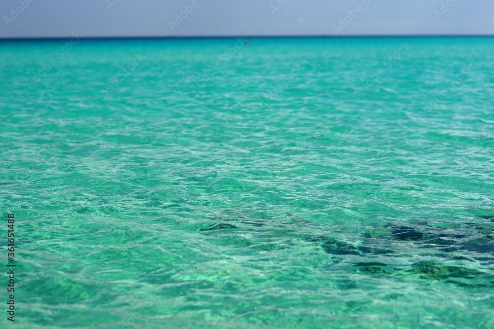 Beautiful tranquil blue green ocean water surface. Selective focus. Shallow depth of field