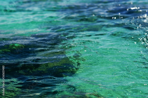 Closeup photo of beautiful tranquil blue green ocean water surface. Selective focus