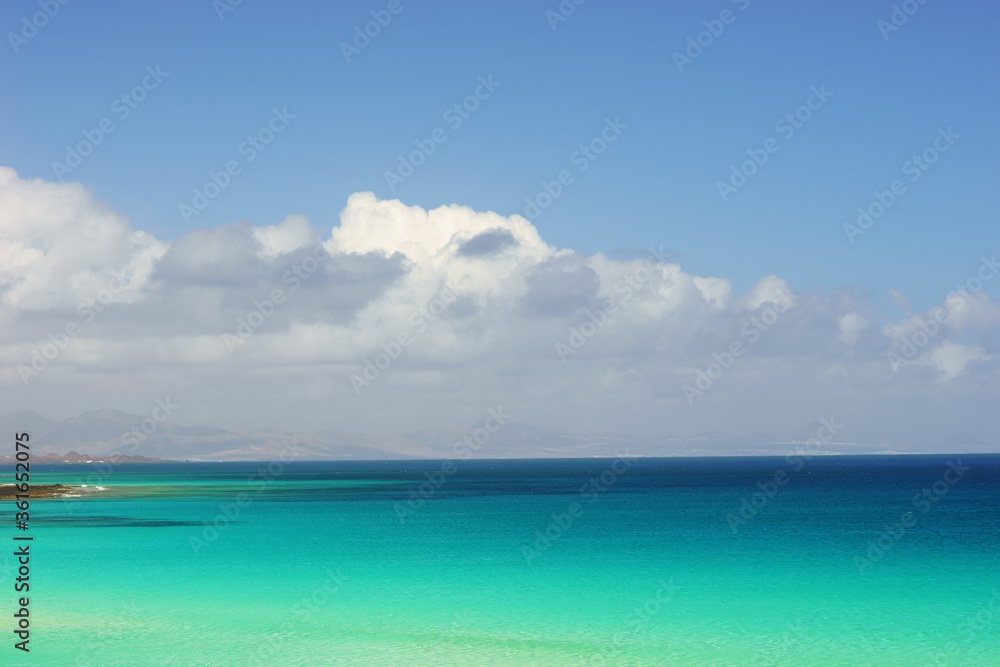 View on beautiful blue green azure ocean water and blue sky with clouds at paradise tropical resort