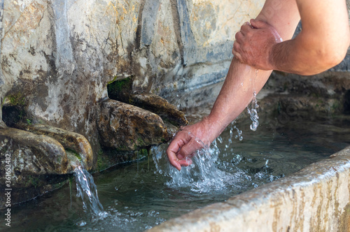 Clean natural spring water, hands and fountain