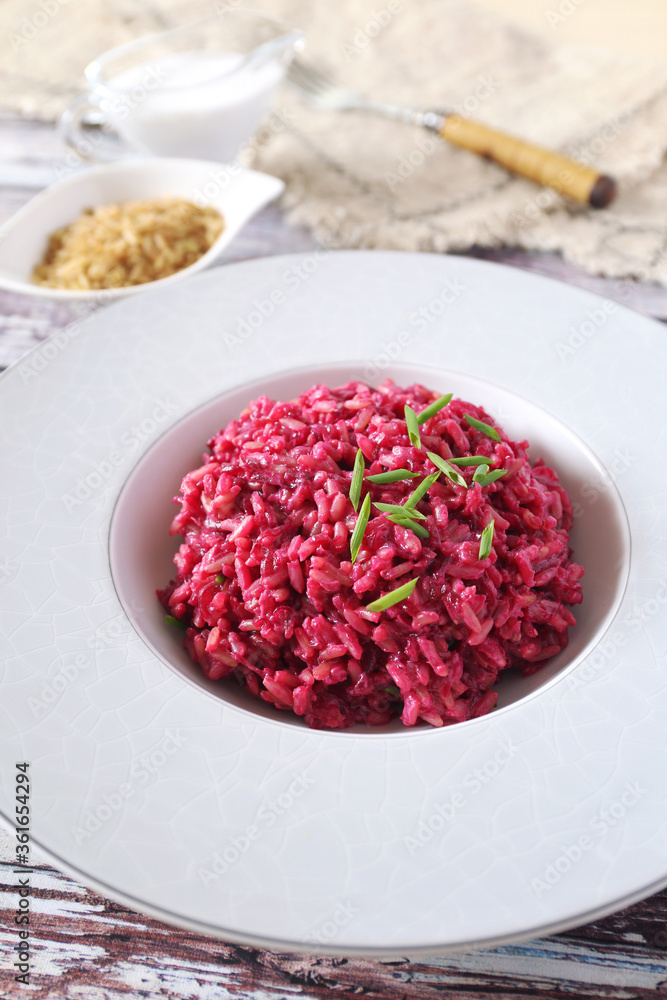 Pink rice. Beetroot risotto from brown rice with almond milk. Diet food. Pink rice. Beetroot risotto from brown rice with almond milk. Diet food.