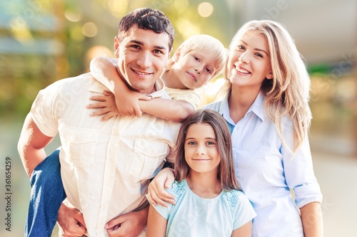 Beautiful smiling lovely family on outdoor background