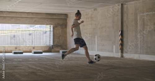 Teenager girl football soccer player practicing
