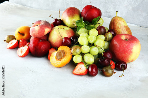 Fresh summer fruits with apple  grapes  berries  plums and healthy apricot.