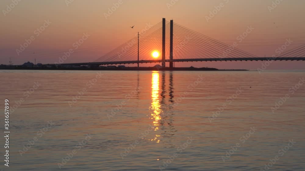 Silhouette of the Indian River Bridge during sunrise near Indian River Inlet, Delaware, U.S.A Silhouette of the Indian River Bridge during sunrise near Indian River Inlet, Delaware, U.S.A