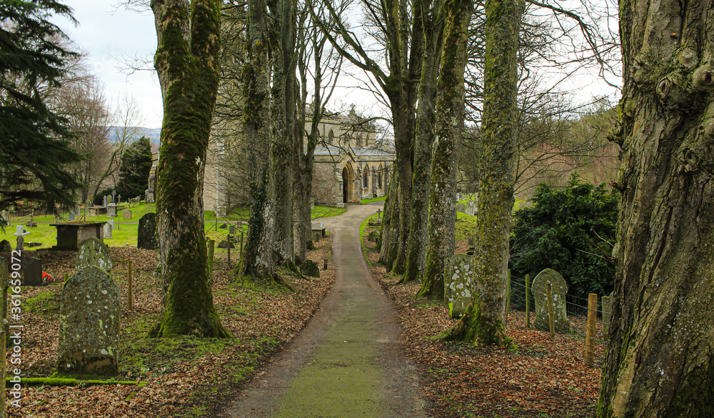 Fototapeta premium Small old church in the UK surrounded by trees