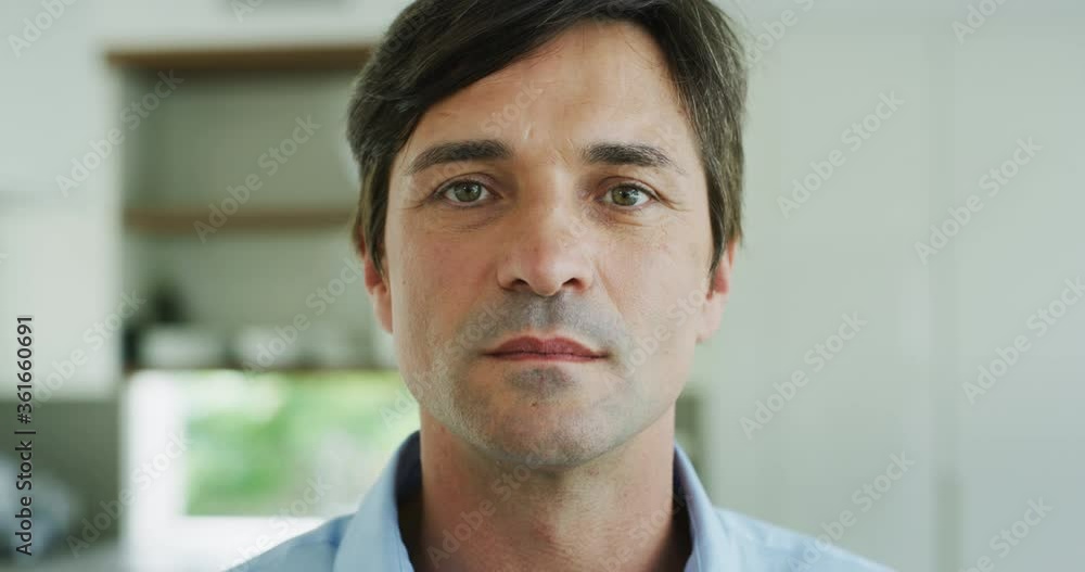 Close up of handsome happy man is smiling in camera after having a breakfast in a kitchen at home. Close up of handsome happy man is smiling in camera after having a breakfast in a kitchen at home.
