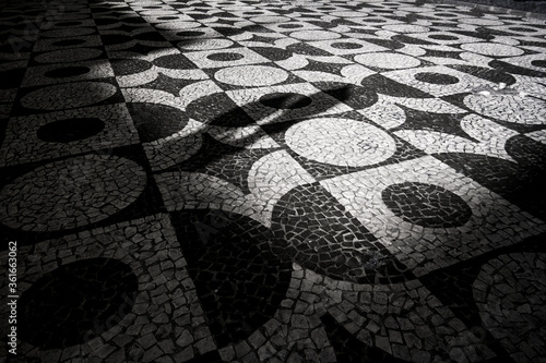 Tableau sur toile Foto em preto e branco das paternas da calçada de pedra em Curitiba, Paraná
