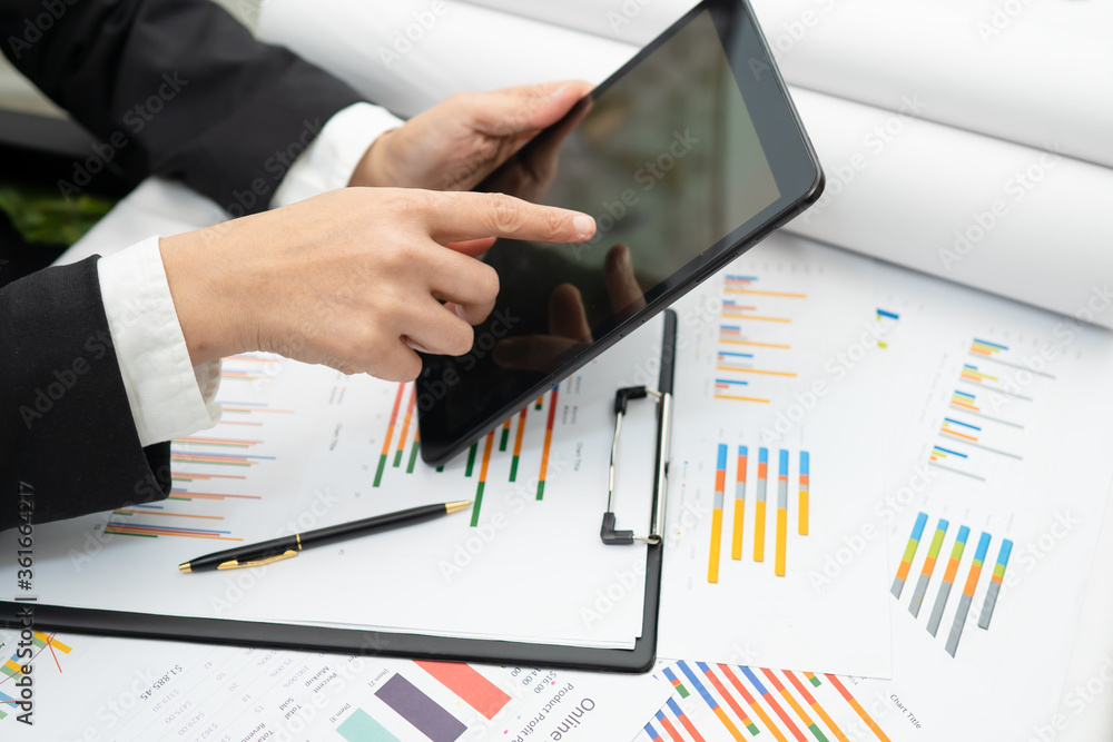 Accounting press tablet with calculator chart graph for working project in modern office. Accounting press tablet with calculator chart graph for working project in modern office.