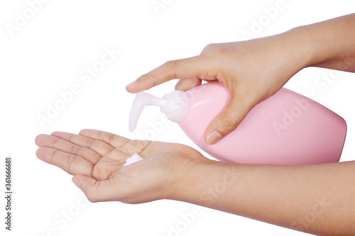 women hands holding body cream pump bottle isolated on white background.