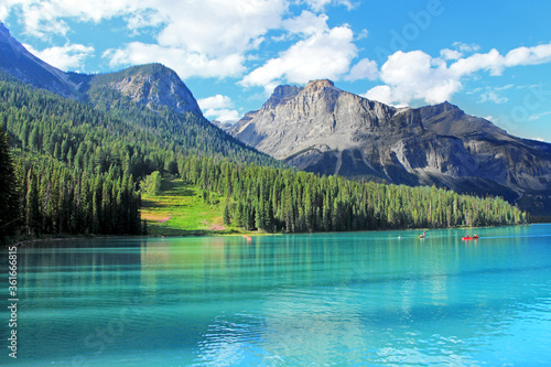  Emerald lake in Yoho National Park, BC. The view on turquoise lake surrounded by pine tree woos and rocky cliffs. 