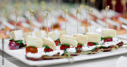 lots of canapes on white trays on a white table