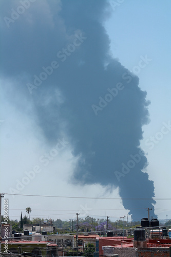 Ciudad de Celaya con un cielo azul lleno de humo y contaminando photo
