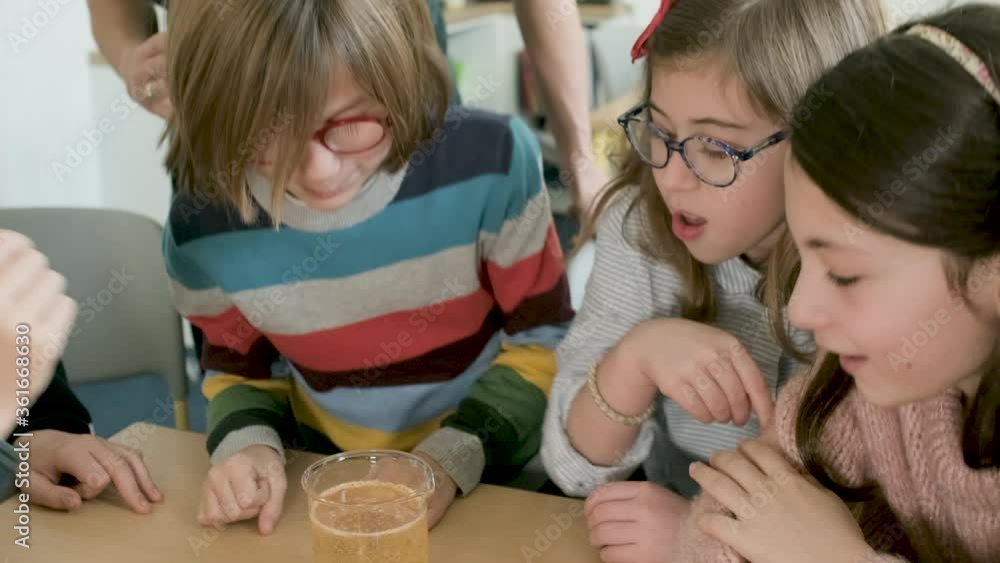 Children in a science lesson with a teacher Children in a science lesson with a teacher