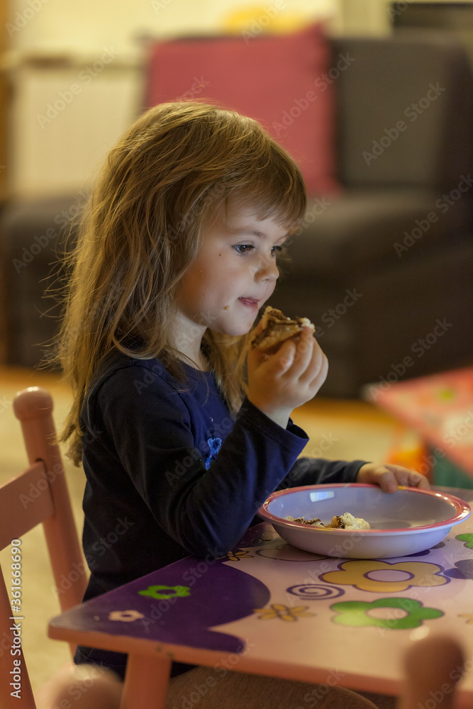 a little girl eating a donut