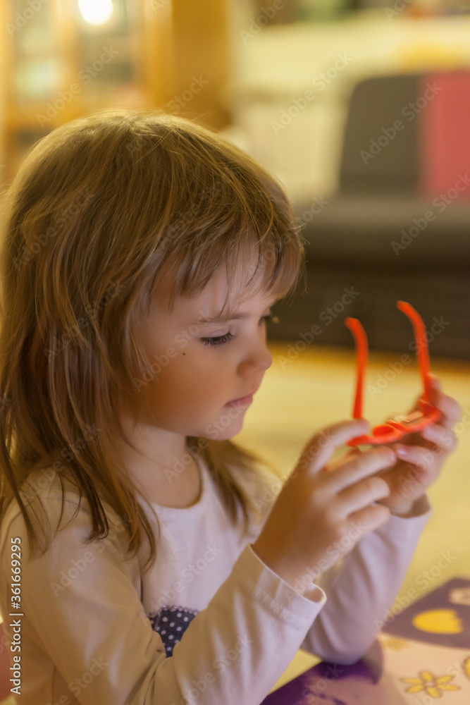 toddler playing with glasses