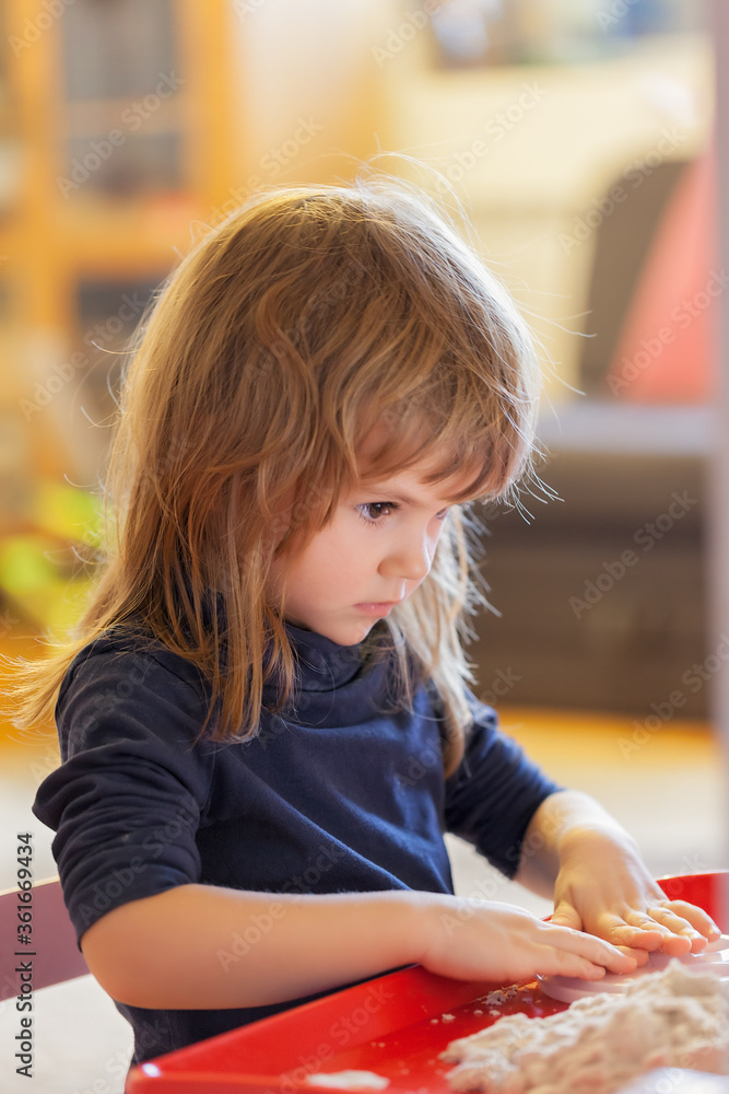 little girl playing with kinetic sand