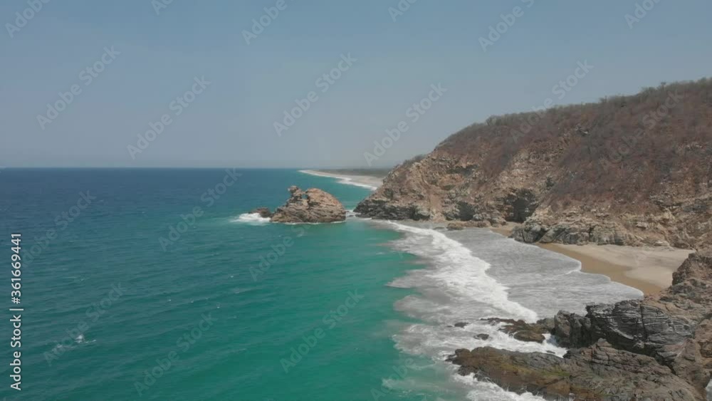 Aerial view of virgin beach in sunny day. Aerial view of the Pacific Ocean. Drone view of rocks in a virgin beach. Top view of ocean. Aerial view of virgin beach in sunny day. Aerial view of the Pacific Ocean. Drone view of rocks in a virgin beach. Top view of ocean.