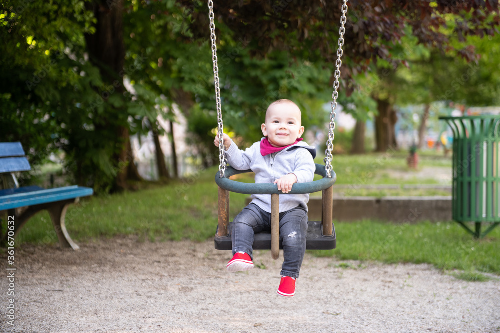 Child Swinging on Swing in a Park