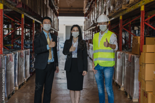 business people with face mask have business talk in factory warehouse © Mongkolchon