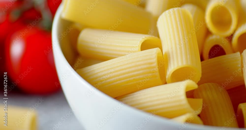Dry cannelloni pasta in a bowl slowly rotates. Dry cannelloni pasta in a bowl slowly rotates.