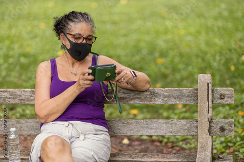 Senior Woman with Mask Checking Phone