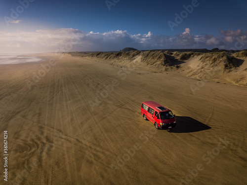 Ninety miles beach with red van, New Zealand