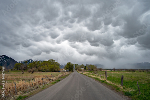 Road leading into mammatus cloud landscape in Utah