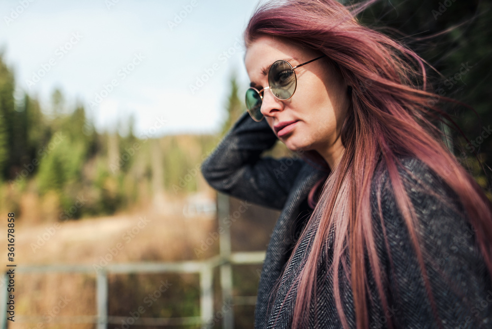 A girl of European appearance in a gray coat and glasses A girl of European appearance in a gray coat and glasses