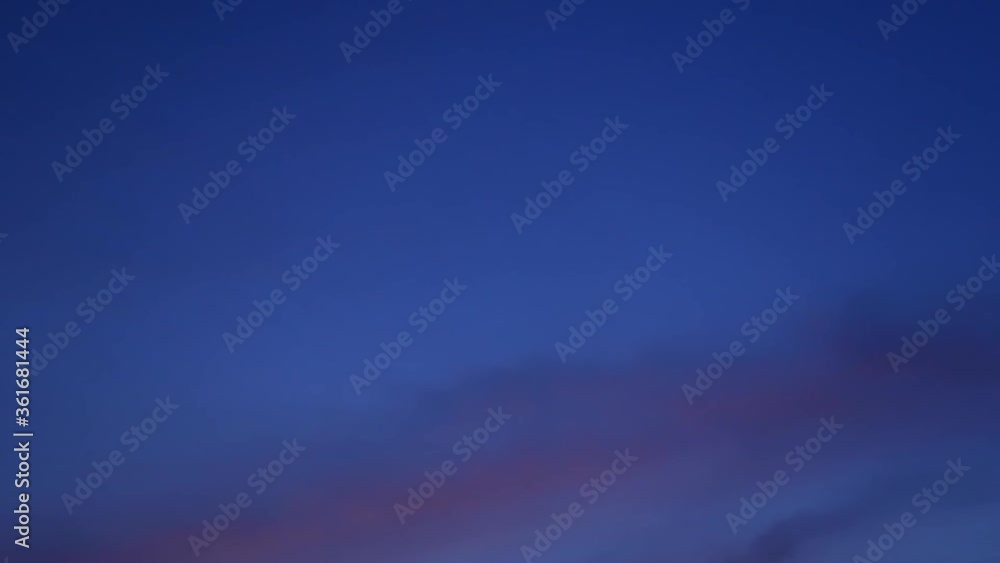 TimeLapse of Colorful pastel sunset sky with wispy smoke cirrus or cirrostratus clouds & dark cirrocumulsus cloudscape slowly moved on evening twilight horizon in tropical summer or spring sun light TimeLapse of Colorful pastel sunset sky with wispy smoke cirrus or cirrostratus clouds & dark cirrocumulsus cloudscape slowly moved on evening twilight horizon in tropical summer or spring sun light