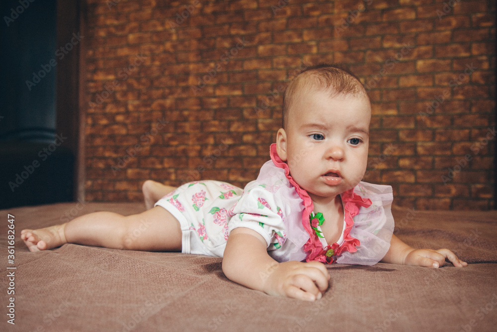 A newborn baby is lying on its stomach. The baby learns to hold its head. manifestation of love. Healthcare concept, parenting, children's day, medicine, IVF, training A newborn baby is lying on its stomach. The baby learns to hold its head. manifestation of love. Healthcare concept, parenting, children's day, medicine, IVF, training