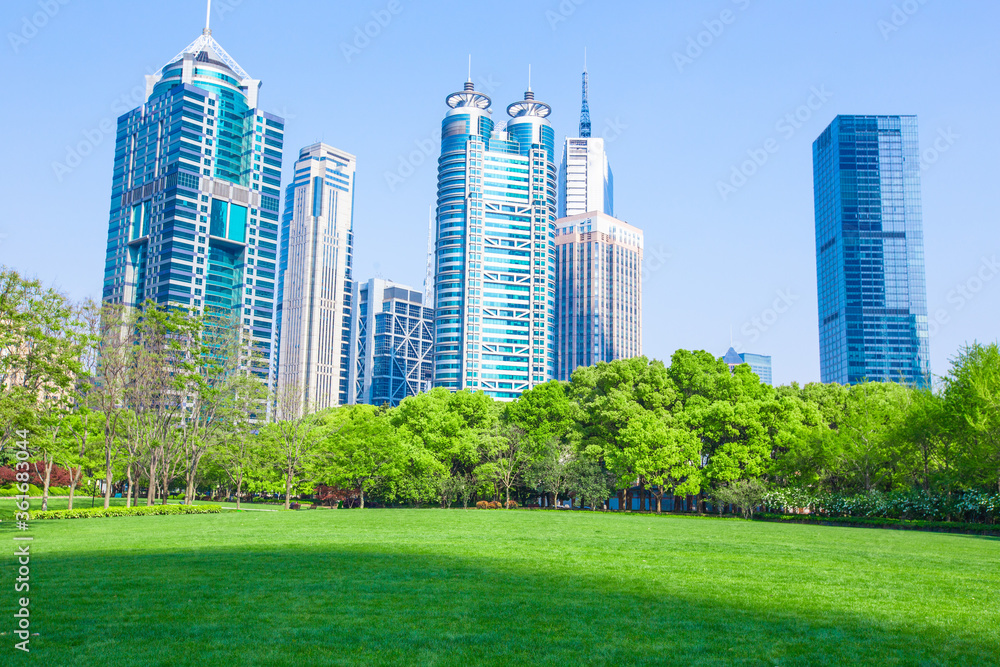 Naklejka premium Central Park in Lujiazui, a big lawn in front of the modern skyscrapers.