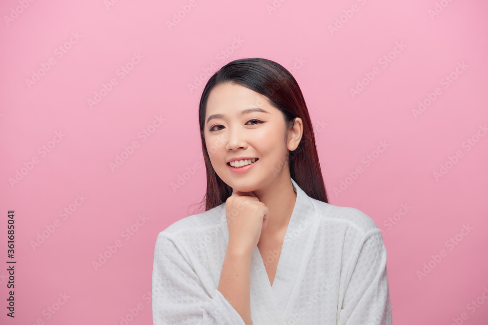 Charming woman with clean skin smiling with white teeth, keeping hands under chin over pink background Charming woman with clean skin smiling with white teeth, keeping hands under chin over pink background