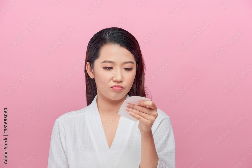 Skin care. Woman holding facial oil blotting paper portrait. Skin care. Woman holding facial oil blotting paper portrait.