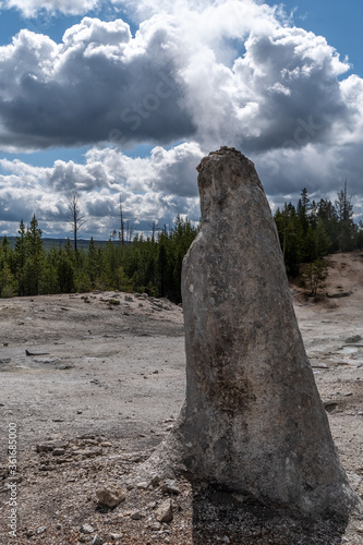 A chimney formed by geyser activity allowing steam to erupt from the top of the cone surrounded by white sinter gravel and other thermal features, Monument Geyser, Monument Basin photo