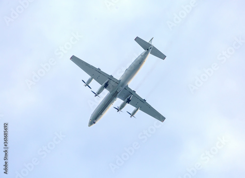 Turboprop aircraft flying through the sky at low altitude