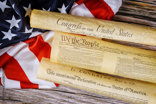 Close up of a replica of U.S. document of American constitution We the people with USA Flag. photo