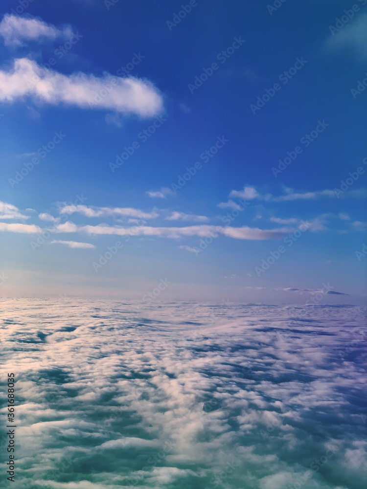 Fototapeta premium cloud and sky with a pastel rainbow-colored background. The sky is taken from a plane