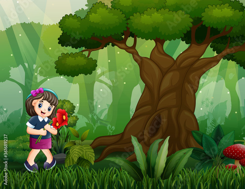 Happy girl picking flowers in the woods