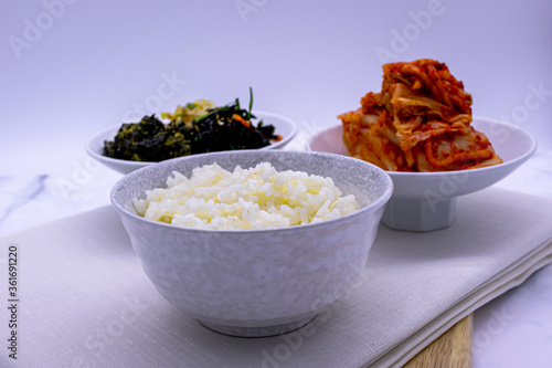 Korean food with rice, kimchi, side dishes.