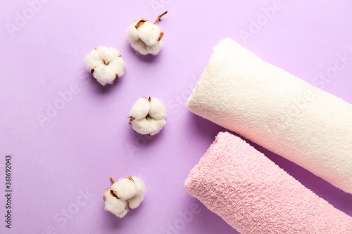 Cotton flowers and soft towels on color background © Pixel-Shot